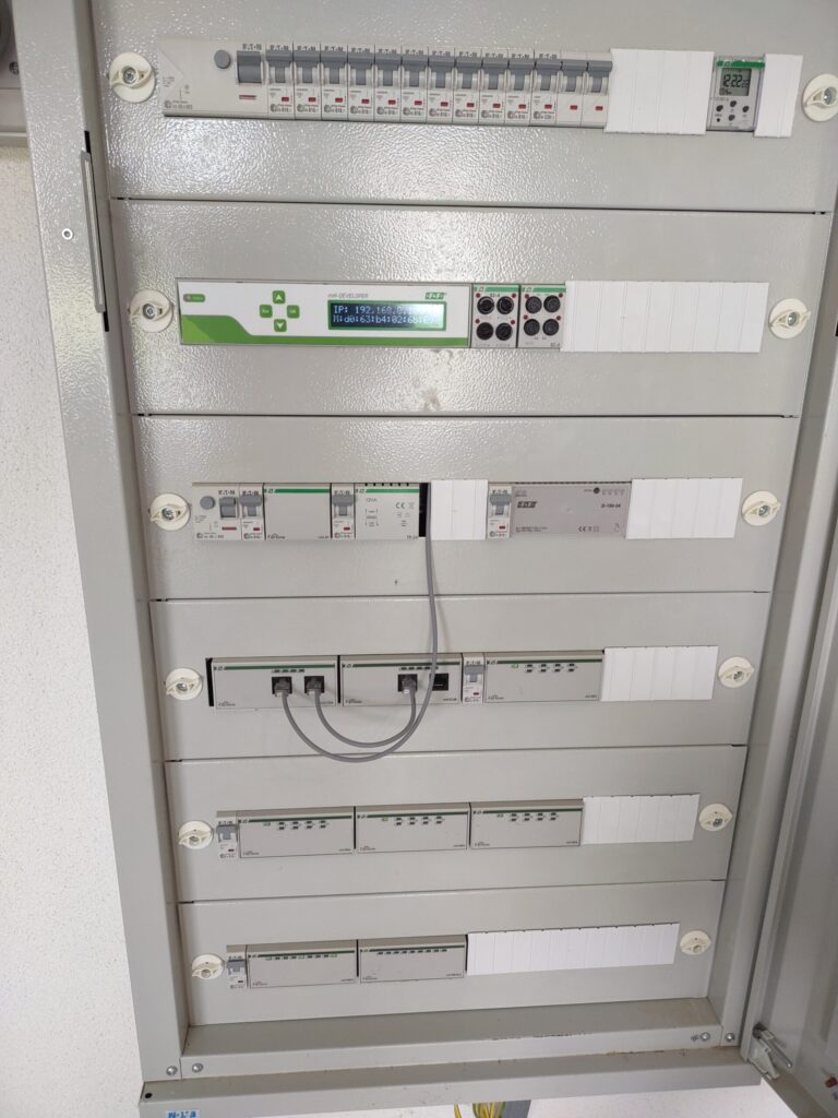 Skrzynka rozdzielcza z zabezpieczeniami elektrycznymi i panelem sterującym.